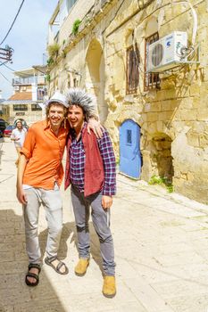 Safed, Israel - March 10, 2020: Jewish men and women in costumes, it is a tradition of Purim (Jewish Holiday). In the old city of Safed (Tzfat), Israel