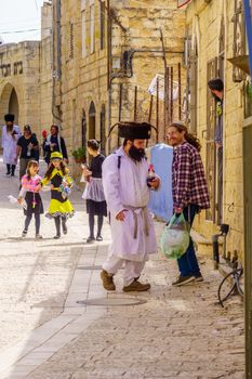 Safed, Israel - March 10, 2020: Jewish men and women in costumes, it is a tradition of Purim (Jewish Holiday). In the old city of Safed (Tzfat), Israel