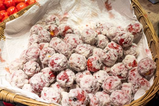 Coated ZaoZi red fruits in a basket in Chengdu, Sichuan province, China