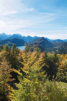 Beautiful nature of European Alps, landscape view of alpine mountains, lake and village on a sunny day, travel and destination scenery