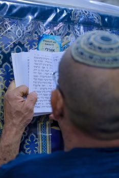 NETIVOT, ISRAEL - JANUARY 13, 2016: Jewish man prays at the Rabbi Israel Abuhaseira (Baba Sali) tomb, as part of the annual hillula of his memory. In Netivot, Israel