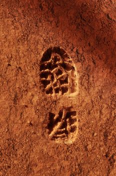 Astronaut footprint in the red sand soil of the planet Mars.