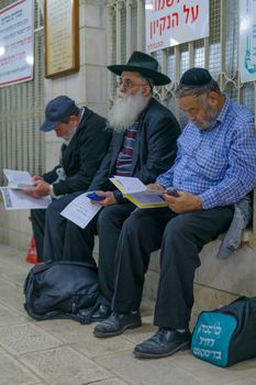 NETIVOT, ISRAEL - JANUARY 13, 2016: Jewish men pray at the Rabbi Israel Abuhaseira (Baba Sali) tomb, as part of the annual hillula of his memory. In Netivot, Israel