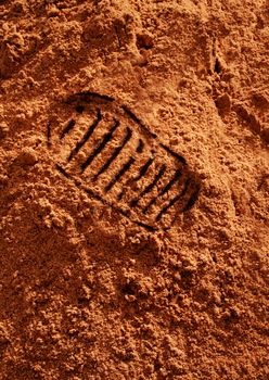 Astronaut bootprint on red sand soil on Mars style background