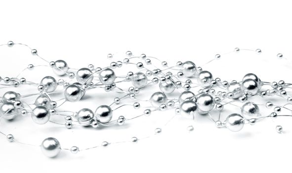 Decorative shiny silver balls chain in white background high-key