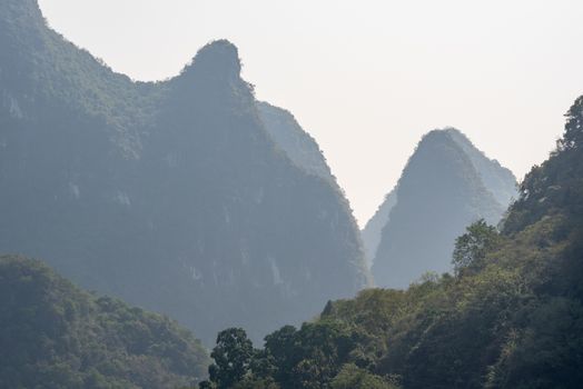 Karst formation and foggy limestone mountain landscape between Guiling and Yangshuo, Guangxi province, China