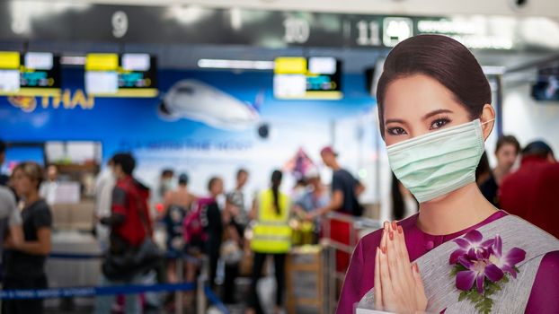 PATTAYA, THAILAND - FEBRUARY 4, 2020: air hostess welcome standee wearing protect mask at check-in area, U-Tapao International Airport terminal during new Coronavirus 2019 infection outbreak situation