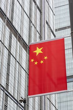 chinese flag close-up view against skyscraper facade