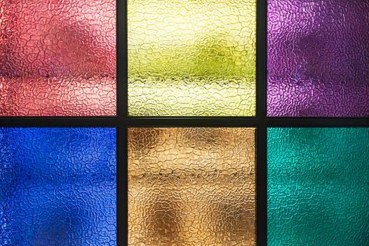 Decorative window of various colored rectangles with light coming through