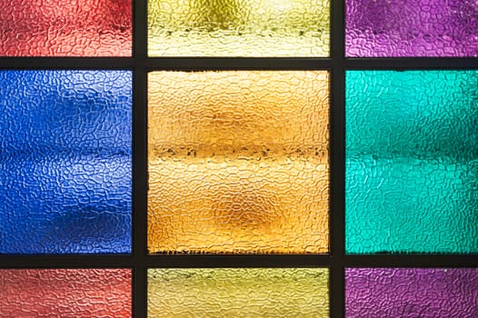 Decorative window of various colored rectangles with light coming through