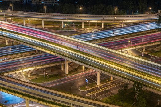 Large interchange with busy traffic aerial view at night in Chengdu, China
