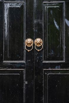 Lion chinese door knockers on a black door in China