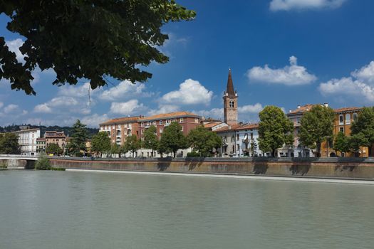 Verona, Italy, Europe, August 2019, view of the River Adige and the tower of the Chiesa Parrocchiale di Santa Maria in Organo