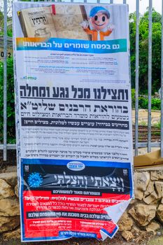 Haifa, Israel - April 14, 2020: Coronavirus pashkevil - note for ultra-orthodox Jews about option to do quarantine time in dedicated hotels, and health services during Passover