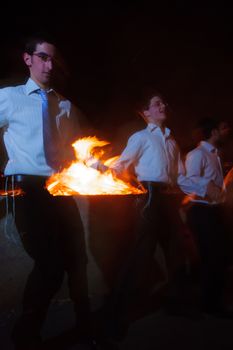 HAIFA, ISRAEL - MAY 01, 2010: Orthodox Jews dance around a bonfire to celebrate the Jewish holiday of Lad-BaOmer, in Haifa, Israel