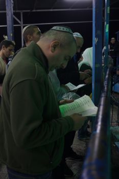 SAFED, ISRAEL - OCTOBER 03, 2014: Jewish men pray Selichot (request for forgiveness) at the tomb of The ARI (Rabbi Isaac Luria), on Yom Kippur eve, in Safed, Israel.