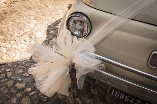 Malcesine, Lake Garda, Italy, August 2019, a wedding decoration on a Fiat 500 bonnet