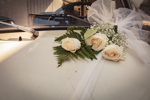 Malcesine, Lake Garda, Italy, August 2019, some wedding flowers on a Fiat 500 bonnet