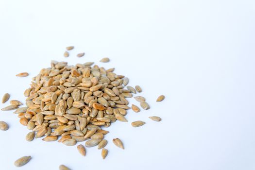 group of peeled sunflower seeds on white background