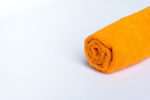 roll orange towel placed on white background