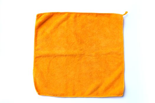 folded orange towel placed on white background