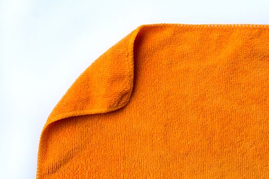 folded orange towel placed on white background