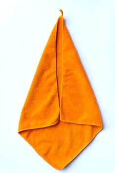 folded orange towel placed on white background