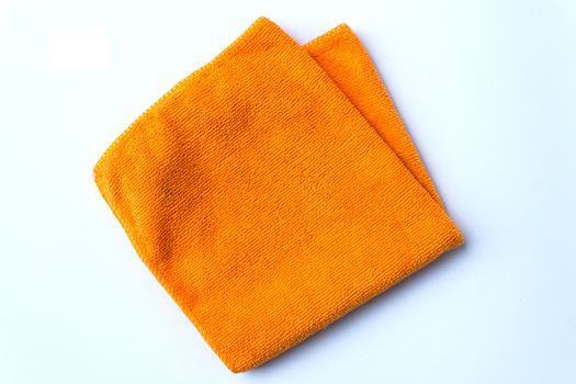 folded orange towel placed on white background