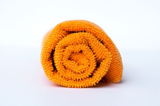 roll orange towel placed on white background