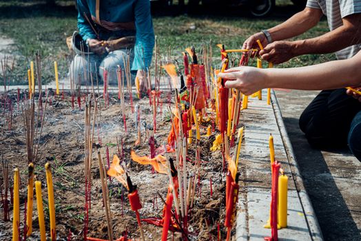 Thai Chinese respect ancestors parents those died by food and burn fake money to sacrifice them at cemetery in Qingming Festival (Qing Ming), Tomb-Sweeping Day