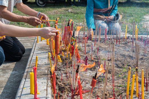 Thai Chinese respect ancestors parents those died by food and burn fake money to sacrifice them at cemetery in Qingming Festival (Qing Ming), Tomb-Sweeping Day