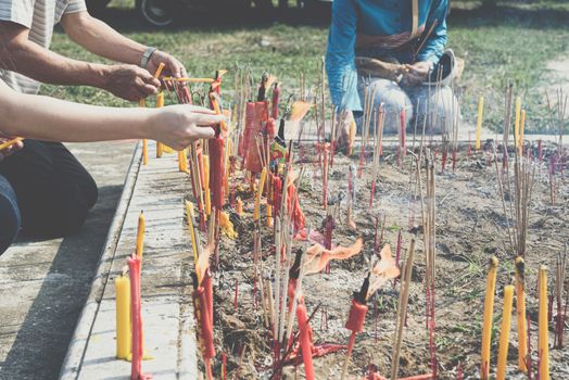 Thai Chinese respect ancestors parents those died by food and burn fake money to sacrifice them at cemetery in Qingming Festival (Qing Ming), Tomb-Sweeping Day