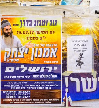 JERUSALEM, ISRAEL - JULY 12, 2017: Combination of posters about religious preaching, and massages, in the ultra-orthodox neighborhood Mea Shearim, Jerusalem, Israel