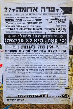 JERUSALEM, ISRAEL - JULY 12, 2017: Pashkevil posters, of the orthodox Jewish community, against women wearing wigs, in the ultra-orthodox neighborhood Mea Shearim, Jerusalem, Israel