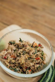 Thai southern spicy Budu salad is anchovies sauce and one of the best known fermented seafood products and herb is a Thai food have a hot and spice in Thai street food market at Bangkok Thailand