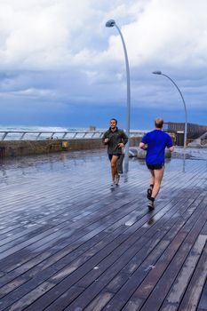 TEL-AVIV - JANUARY 25, 2016: Winter scene, in the Tel-Aviv Port compound, with joggers, Israel. The port compound was restored as a dining and commercial area