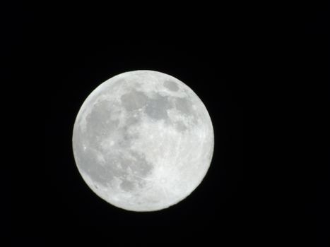 Beautiful caption of the moonlight over the village in winter days with some trees and leaves in the background by night and by day.