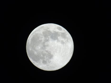 Beautiful caption of the moonlight over the village in winter days with some trees and leaves in the background by night and by day.