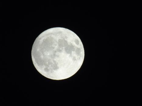 Beautiful caption of the moonlight over the village in winter days with some trees and leaves in the background by night and by day.