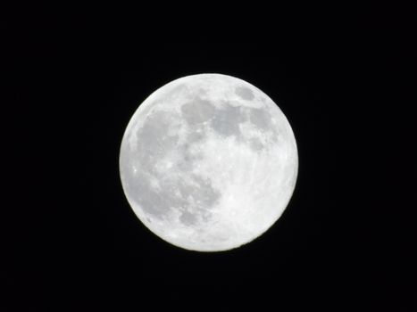 Beautiful caption of the moonlight over the village in winter days with some trees and leaves in the background by night and by day.