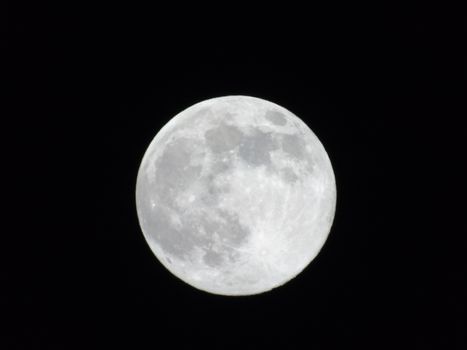 Beautiful caption of the moonlight over the village in winter days with some trees and leaves in the background by night and by day.