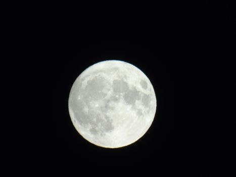 Beautiful caption of the moonlight over the village in winter days with some trees and leaves in the background by night and by day.