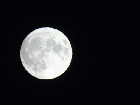 Beautiful caption of the moonlight over the village in winter days with some trees and leaves in the background by night and by day.