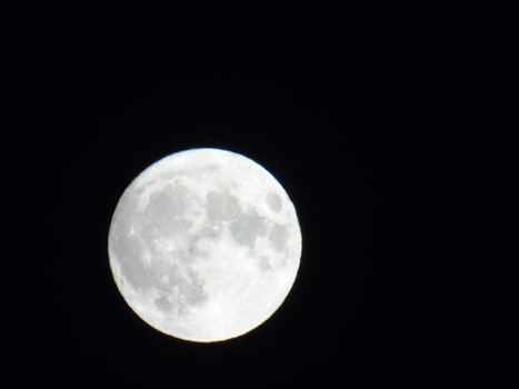 Beautiful caption of the moonlight over the village in winter days with some trees and leaves in the background by night and by day.