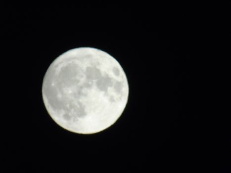 Beautiful caption of the moonlight over the village in winter days with some trees and leaves in the background by night and by day.