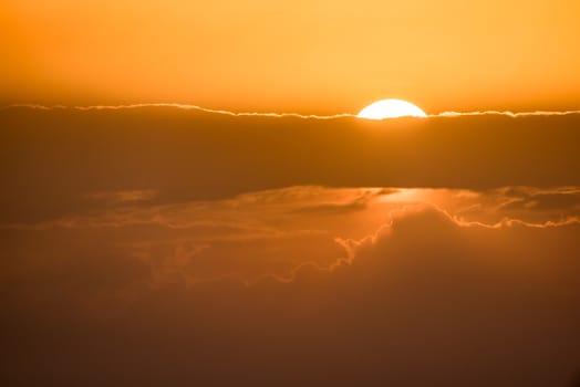 Sunset orange sky background with fluffy clouds