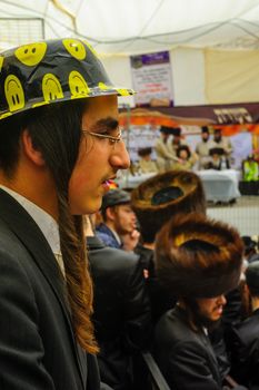 JERUSALEM, ISRAEL - MARCH 25, 2016: A crowd and their Rabbi, part of a celebration of the Jewish Holyday Purim, in the ultra-orthodox neighborhood Mea Shearim, Jerusalem, Israel