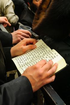 JERUSALEM, ISRAEL - MARCH 25, 2016: Jewish man read a holy book, part of a celebration of the Jewish Holyday Purim, in the ultra-orthodox neighborhood Mea Shearim, Jerusalem, Israel