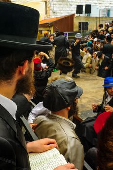 JERUSALEM, ISRAEL - MARCH 25, 2016: Jewish man read a holy book, part of a celebration of the Jewish Holyday Purim, in the ultra-orthodox neighborhood Mea Shearim, Jerusalem, Israel