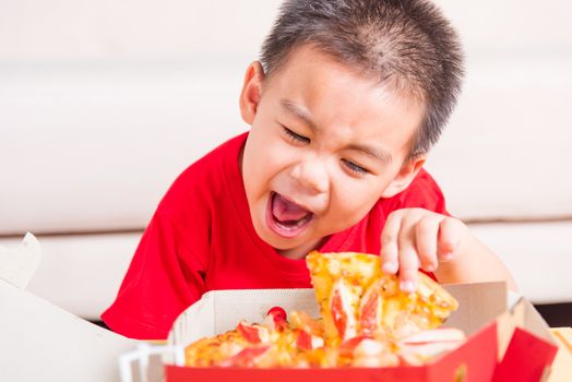 Hot Homemade, Vegetarian fast Italian food, Cute Little Child enjoying holding Delivery Pizza pepperoni, cheese many slices in an open cardboard box at home